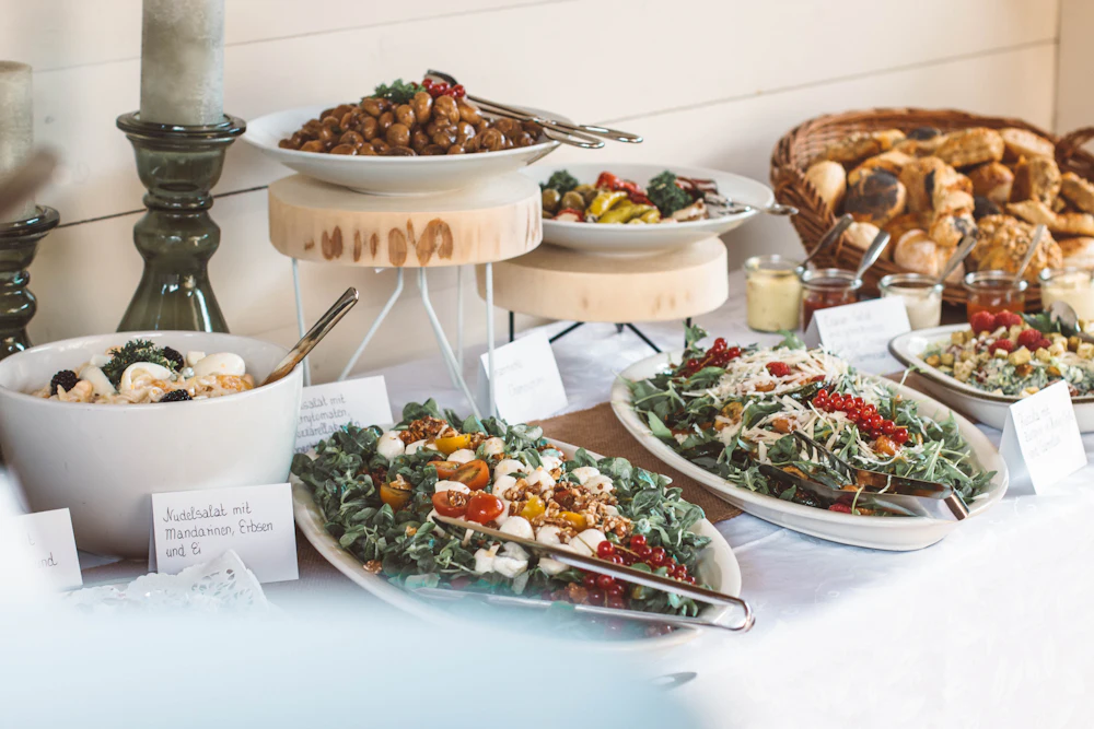 Plates of vegetable dishes on a white table