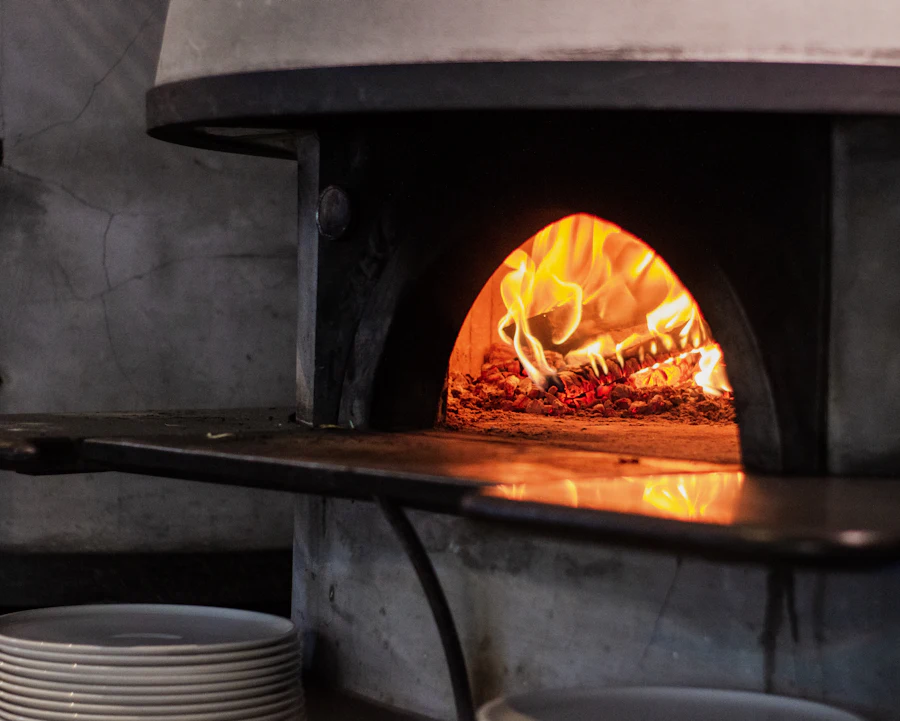 Pizza cooking in a wood-fired oven